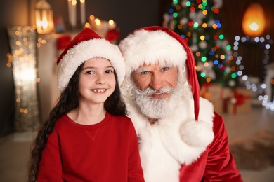 Portrait of little child with Santa Claus at home. Christmas celebration