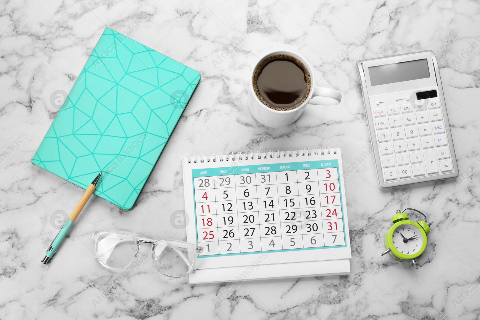 Photo of Flat lay composition with calendar and cup of coffee on white marble table