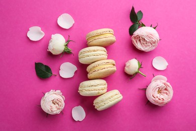 Photo of Flat lay composition with macarons and roses on pink background