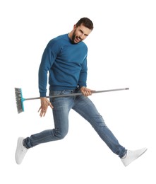 Photo of Man with broom jumping on white background