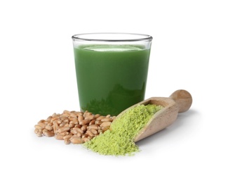 Photo of Glass of wheat grass juice, seeds and scoop with powder on white background
