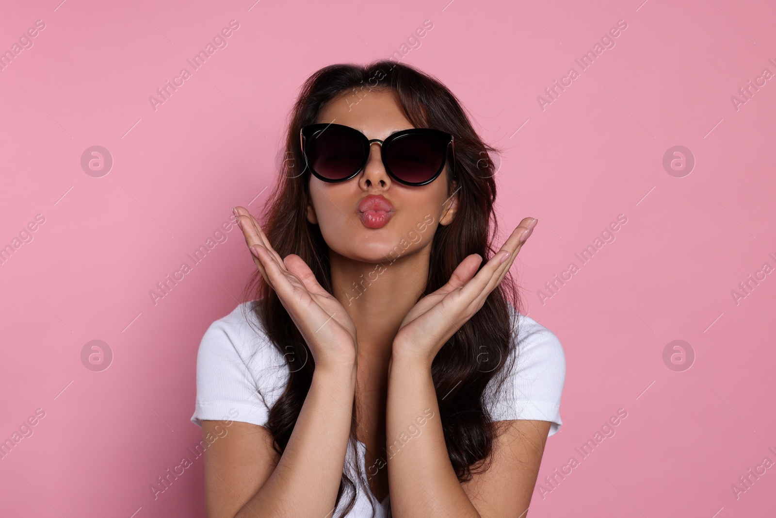 Photo of Beautiful woman with stylish sunglasses on pink background