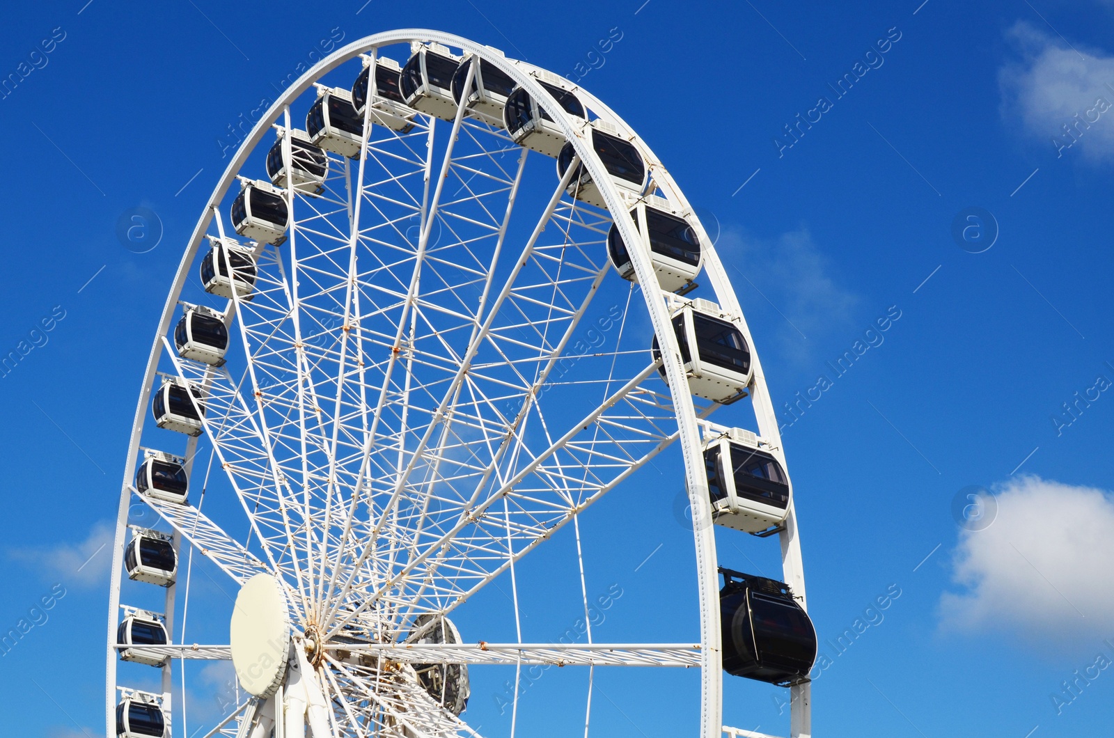 Photo of Beautiful large Ferris wheel against blue sky