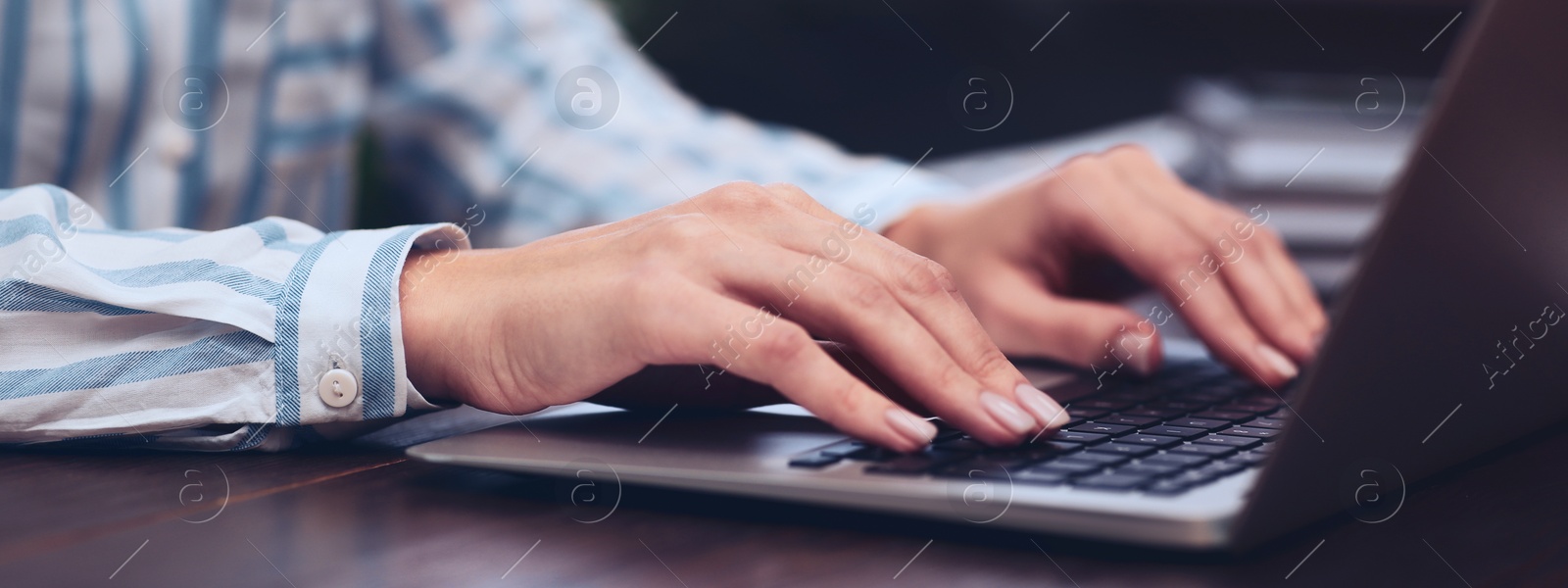 Image of Young woman working on computer at table indoors, closeup. Banner design