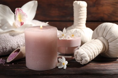 Photo of Composition with spa supplies and flowers on wooden table