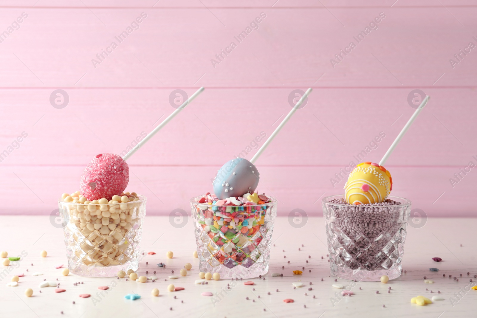 Photo of Egg shaped cake pops for Easter celebration on white wooden table