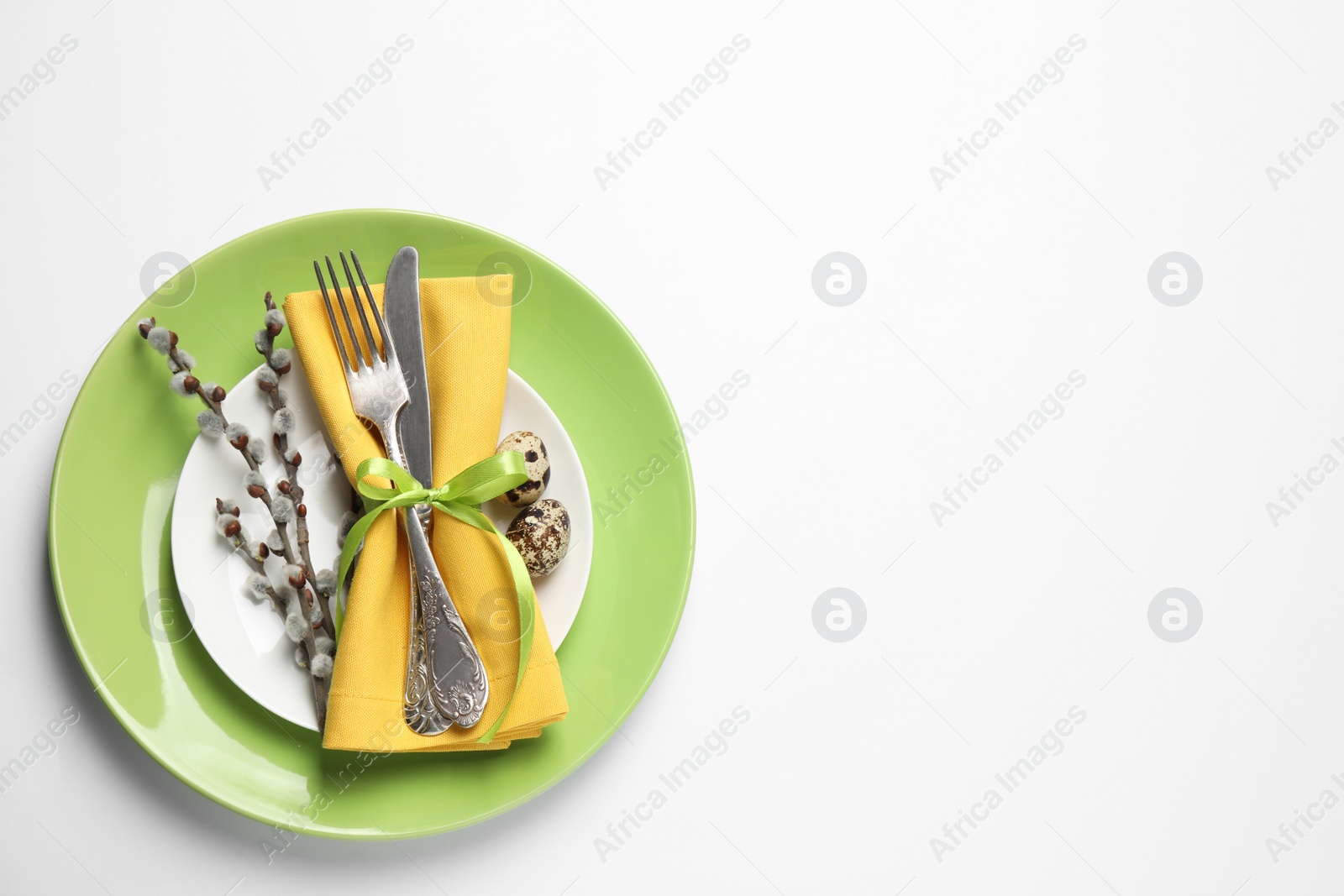 Photo of Festive Easter table setting with floral decor on white background, top view