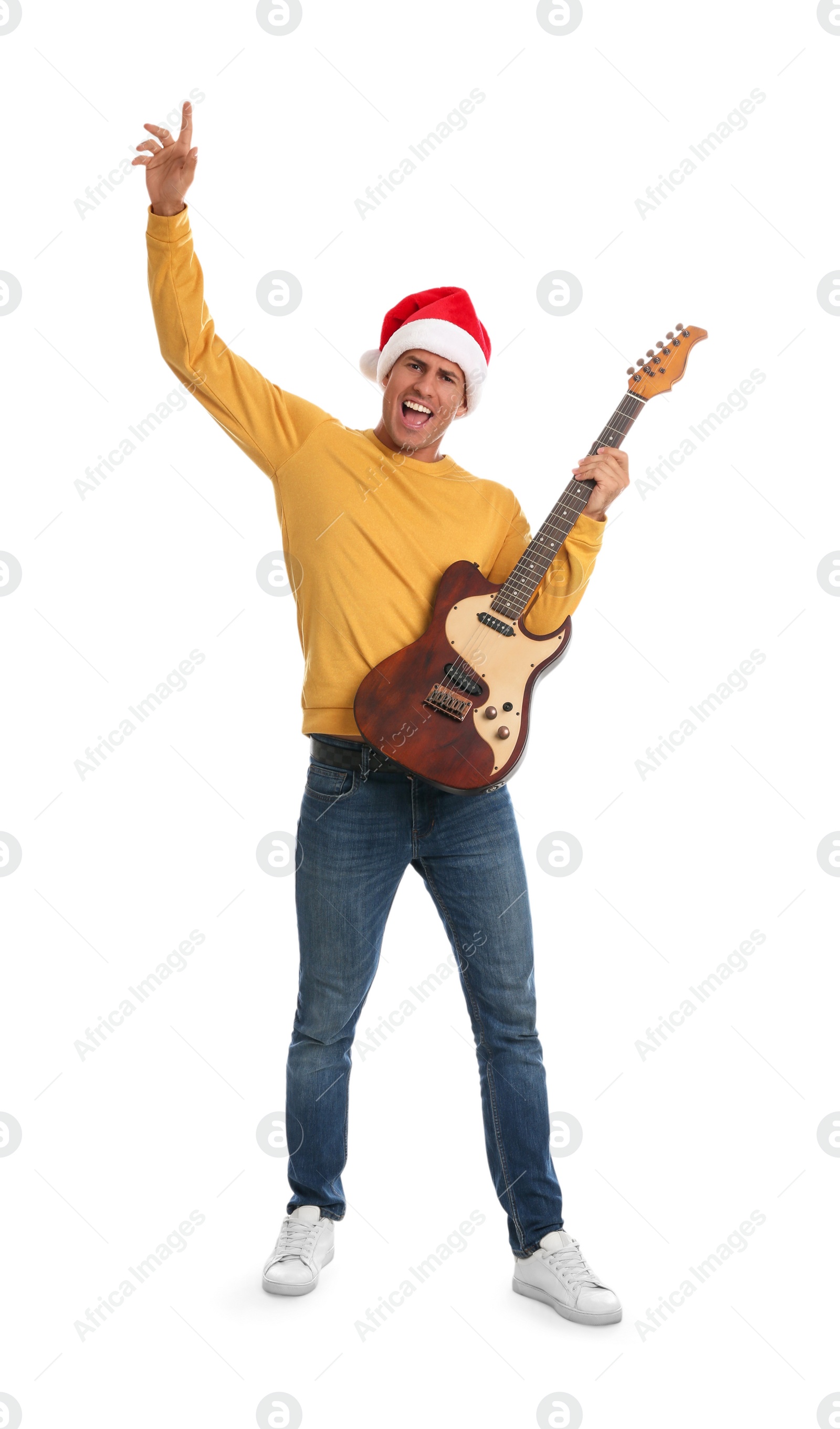 Photo of Man in Santa hat with electric guitar on white background. Christmas music