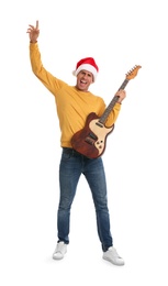 Photo of Man in Santa hat with electric guitar on white background. Christmas music