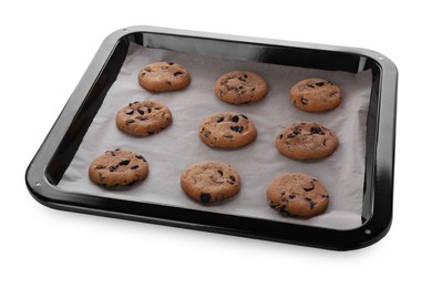 Baking pan with parchment paper and tasty cookies isolated on white