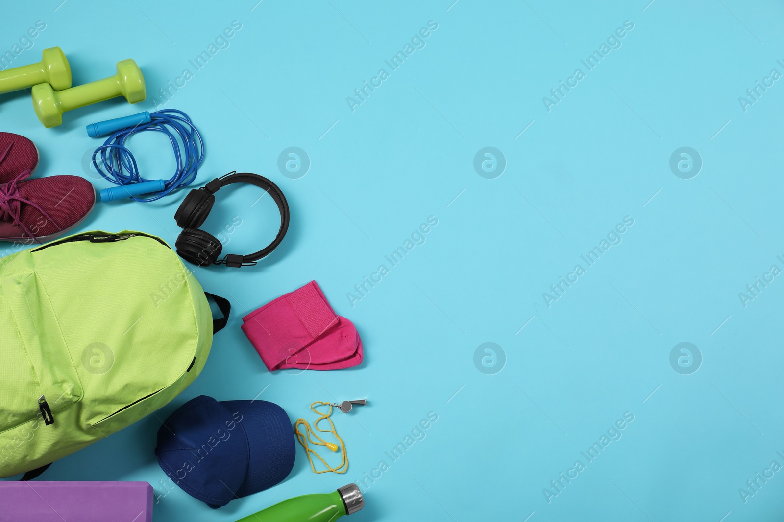 Photo of Different sports equipment on light blue background, flat lay. Space for text