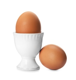 Photo of Raw chicken eggs and holder on white background