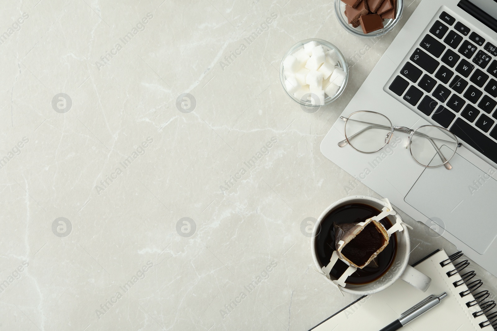 Photo of Flat lay composition with drip coffee in cup on light grey marble table. Space for text