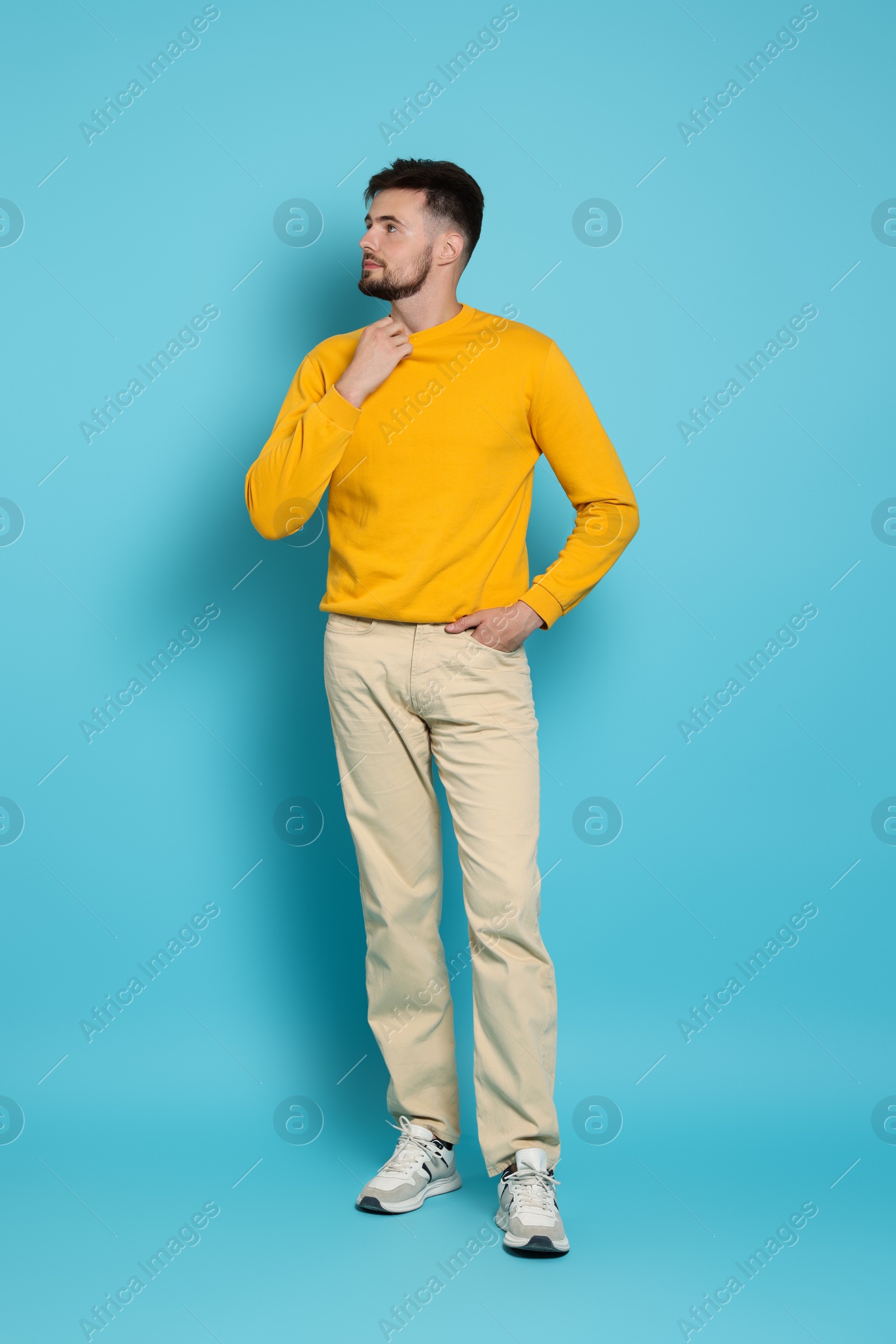 Photo of Full length portrait of handsome man on light blue background