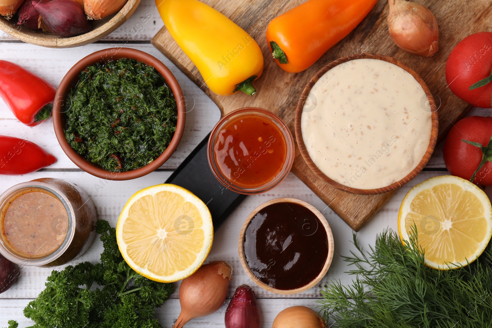 Photo of Different fresh marinades and ingredients on white wooden table, flat lay