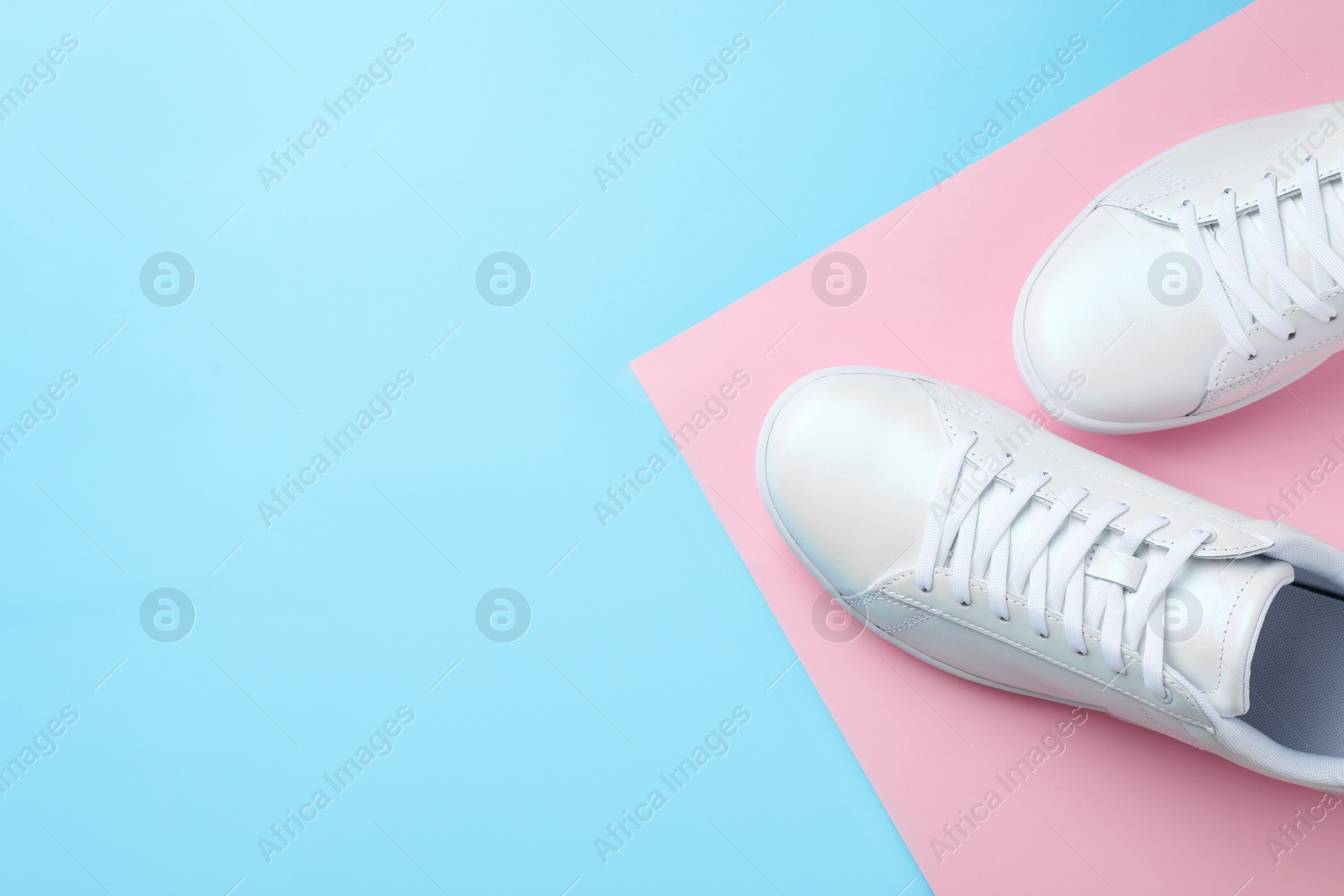 Photo of Pair of sneakers on color background, flat lay. Space for text