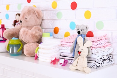 Photo of Baby accessories on shelf near white brick wall