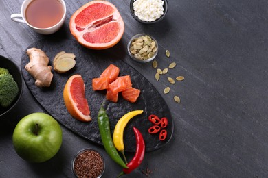 Photo of Metabolism. Different food products on dark grey table, flat lay with space for text