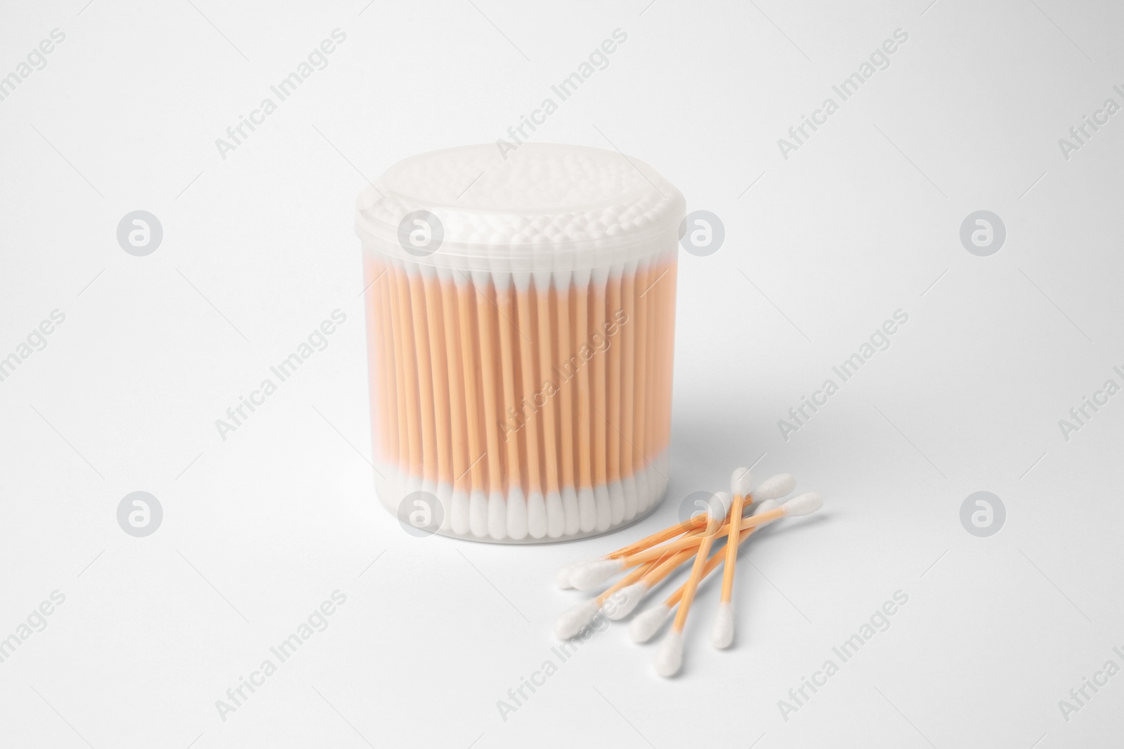 Photo of Cotton buds in plastic container isolated on white