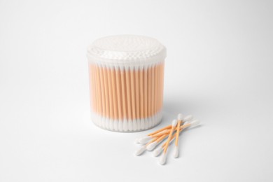 Cotton buds in plastic container isolated on white