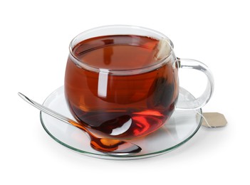 Photo of Brewing aromatic tea. Cup with teabag and spoon isolated on white