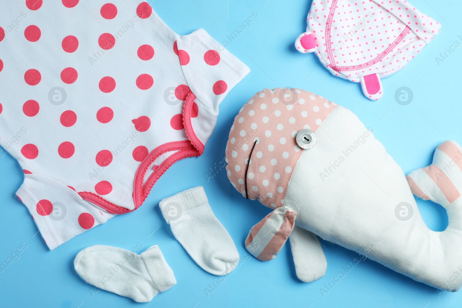 Photo of Flat lay composition with cute clothes on color background. Baby accessories