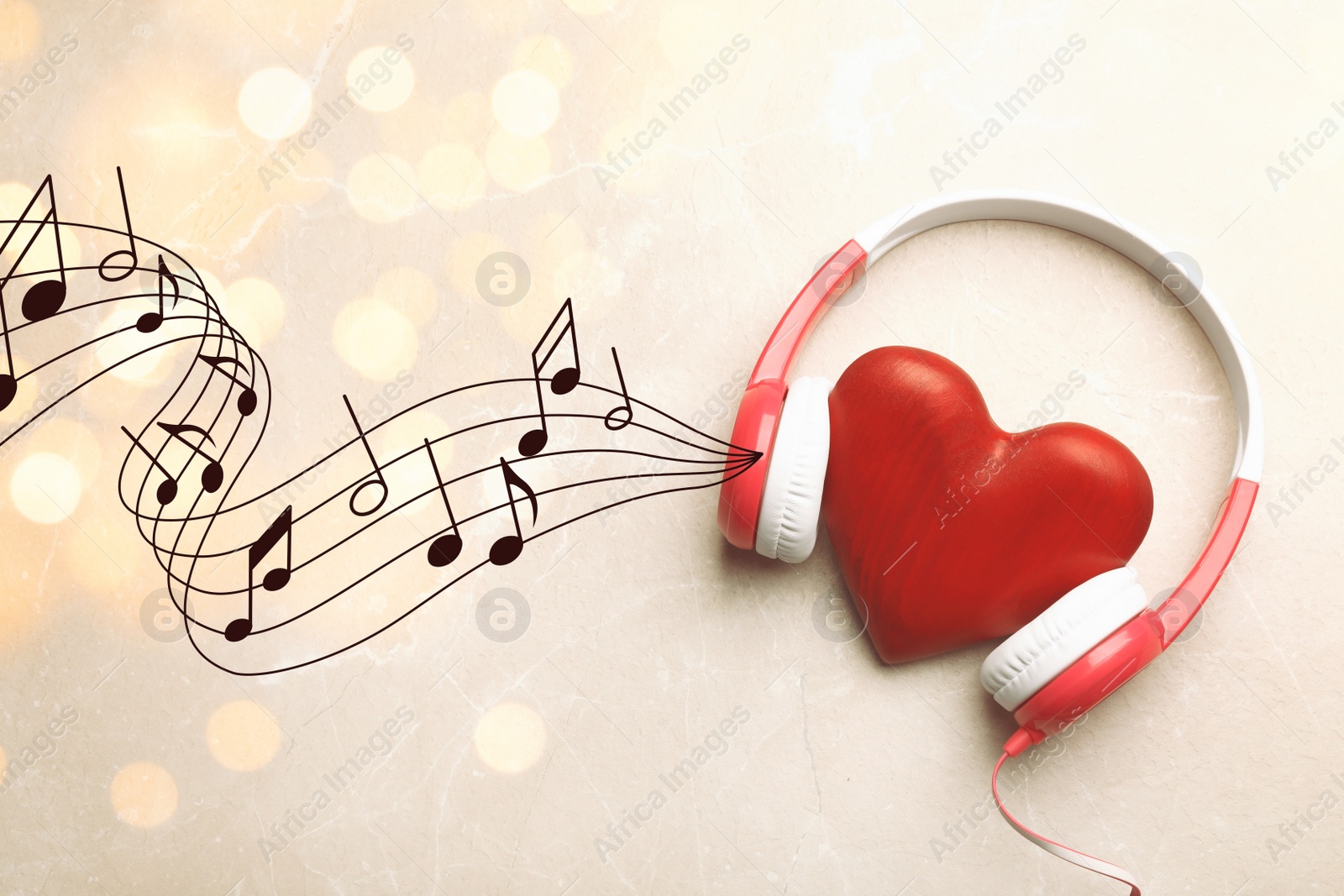 Image of Decorative heart with modern headphones on light background 