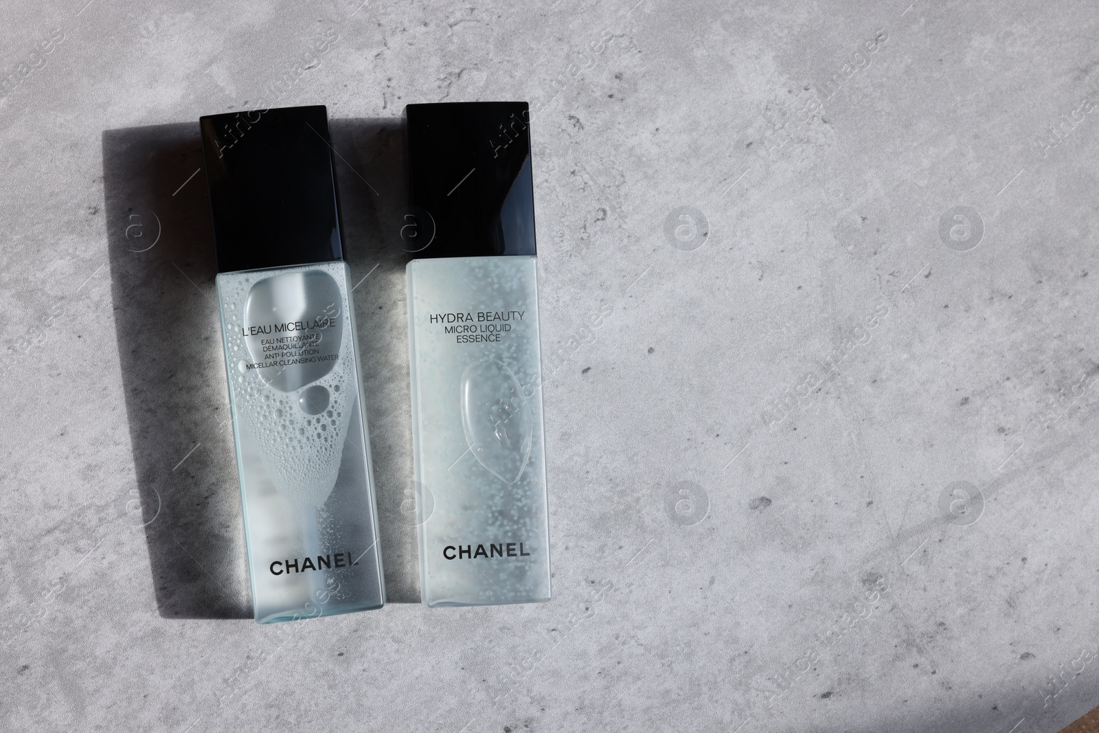 Photo of Leiden, Netherlands - July 14, 2022: Chanel cosmetic products on light grey table, flat lay. Space for text