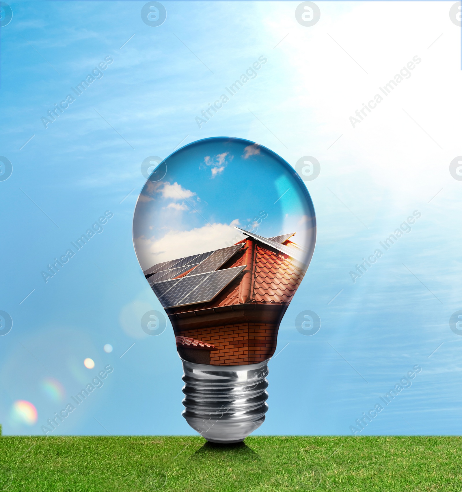 Image of Alternative energy source. Light bulb with solar panels outdoors