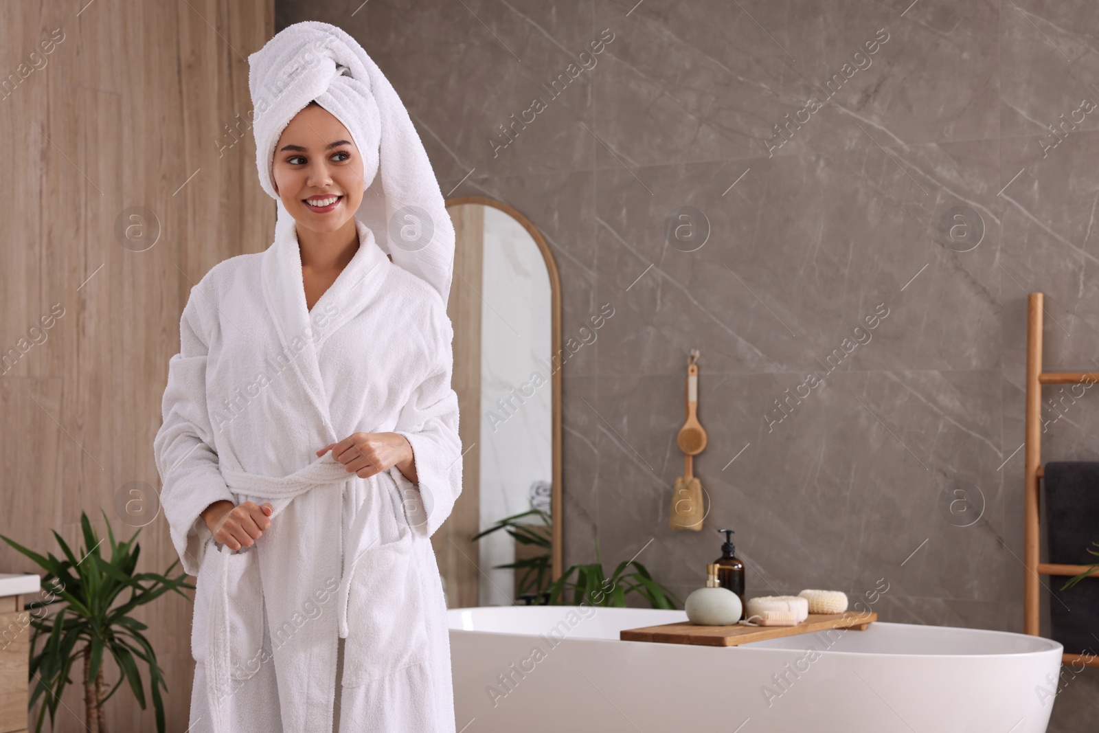 Photo of Beautiful African American woman in bathroom, space for text