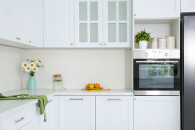 Photo of Modern kitchen interior with stylish white furniture