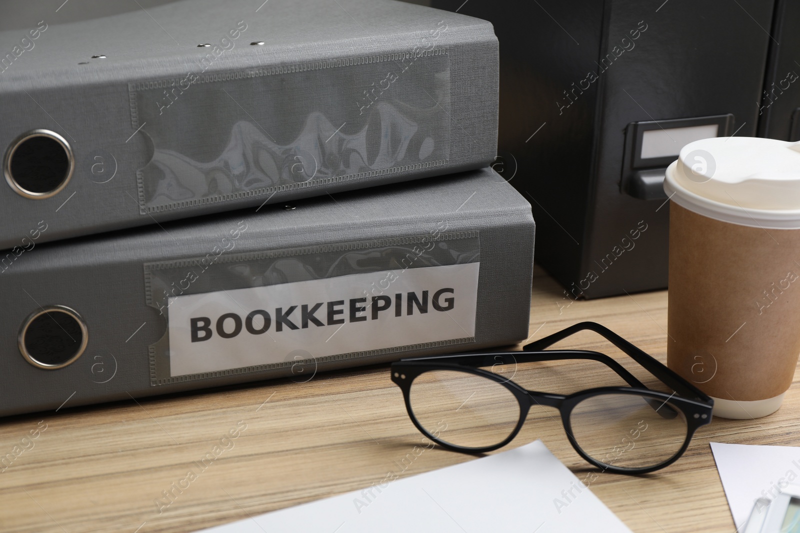 Photo of Bookkeeper's workplace with folders and documents on table