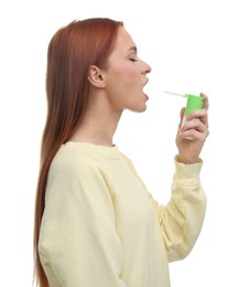 Photo of Young woman using throat spray on white background