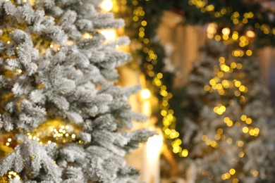 Photo of Beautiful decorated Christmas tree with festive lights on blurred background, closeup. Space for text