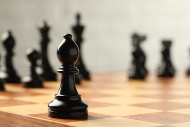 Photo of Chessboard with game pieces on light background, closeup. Space for text