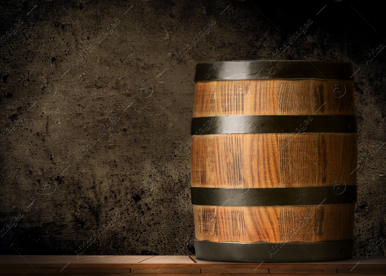 Image of One wooden barrel against dark textured background, space for text