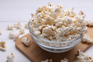 Tasty popcorn on white wooden table, closeup