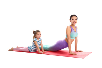 Woman and daughter doing yoga together on white background. Home fitness