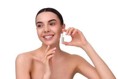 Photo of Beautiful young woman holding skincare ampoule on white background