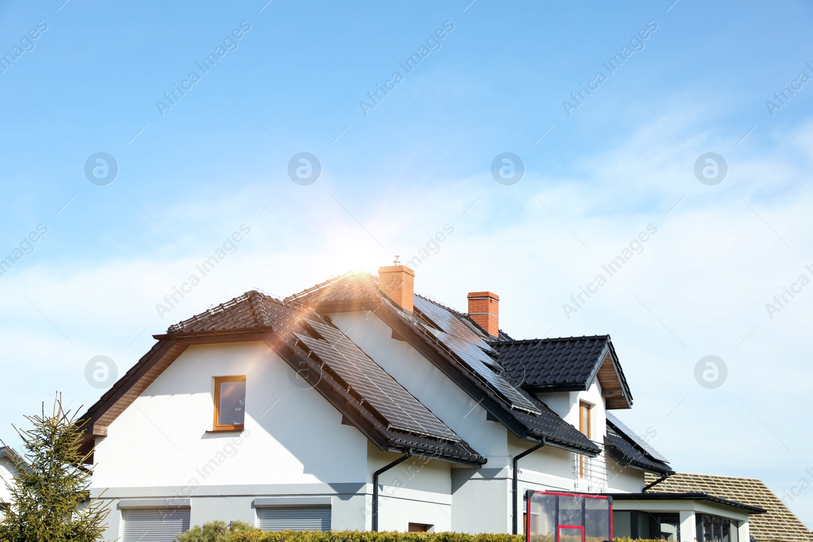 Photo of House with installed solar panels on roof, space for text. Alternative energy