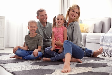 Happy family with children on floor at home