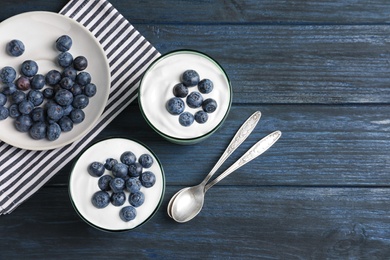 Photo of Glasses with yogurt, berries and granola on table, top view