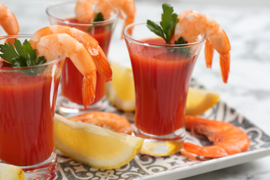 Photo of Delicious shrimp cocktail with tomato sauce, closeup