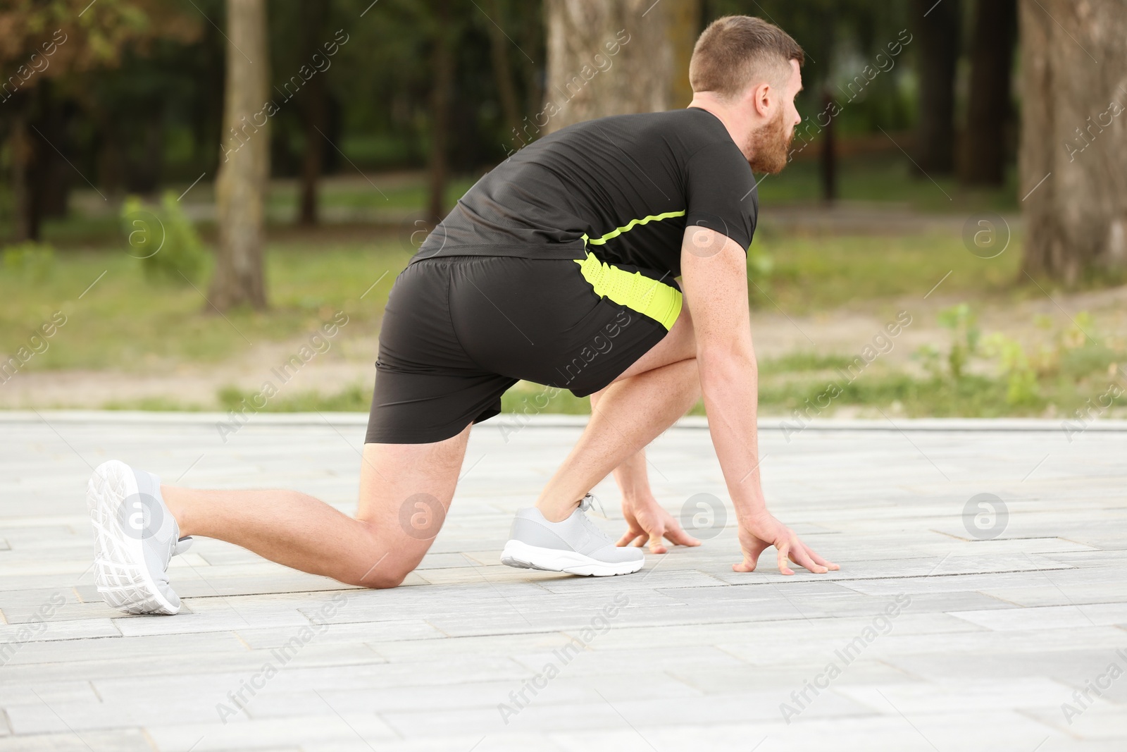 Photo of Young man ready for running outdoors on sunny day