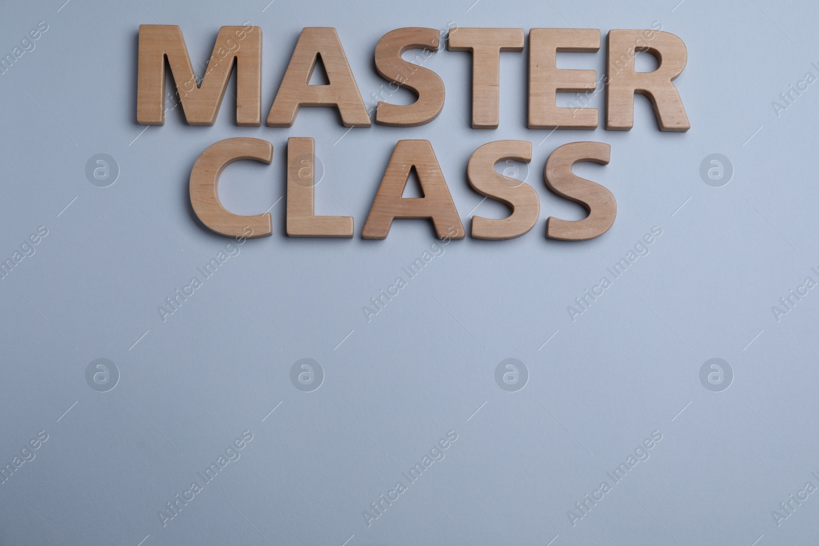 Photo of Phrase Master class made of wooden letters on grey background, flat lay. Space for text