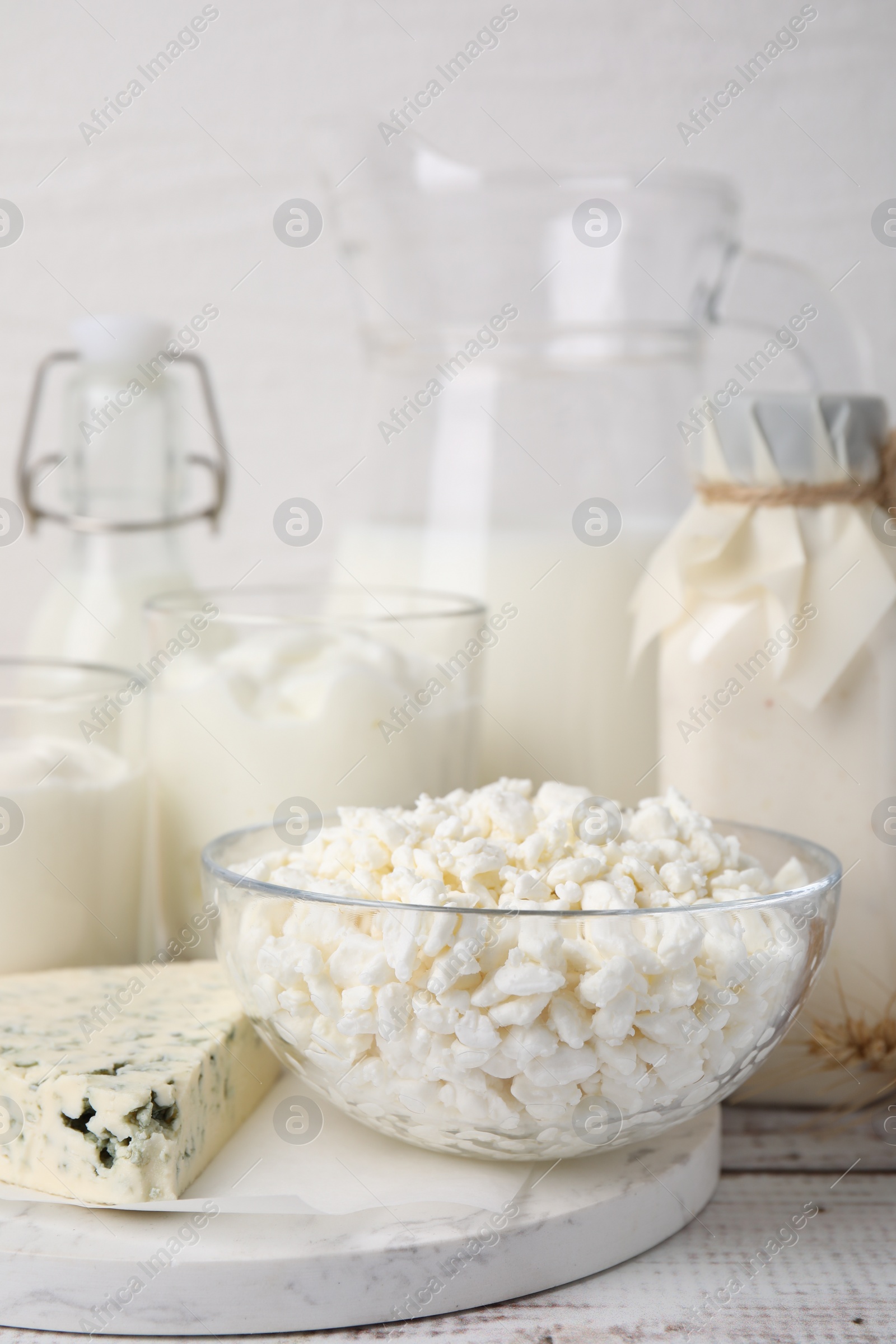 Photo of Different fresh dairy products on white wooden table