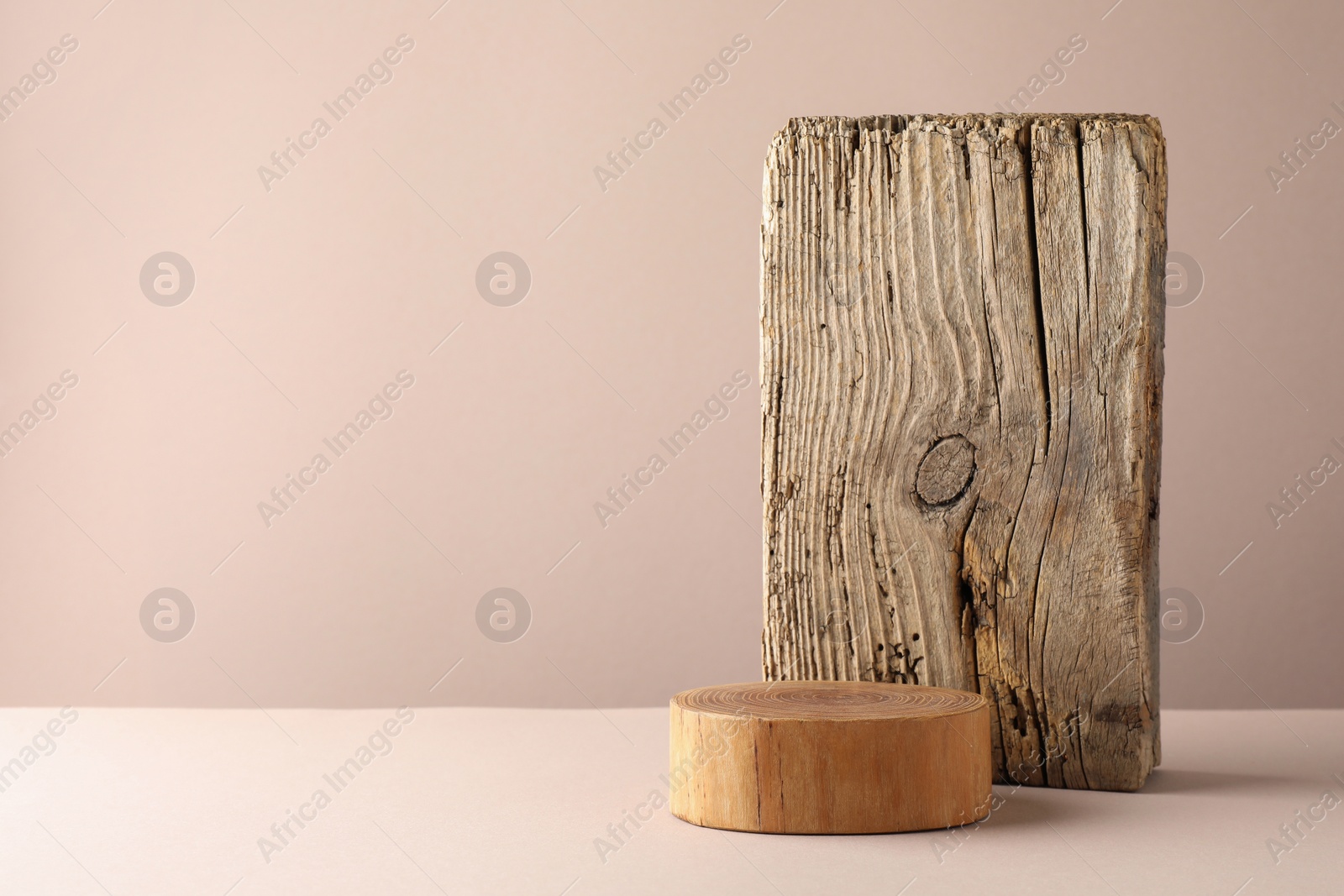 Photo of Presentation for product. Wooden podium on beige background. Space for text