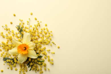 Beautiful floral composition with mimosa flowers on beige background, flat lay. Space for text