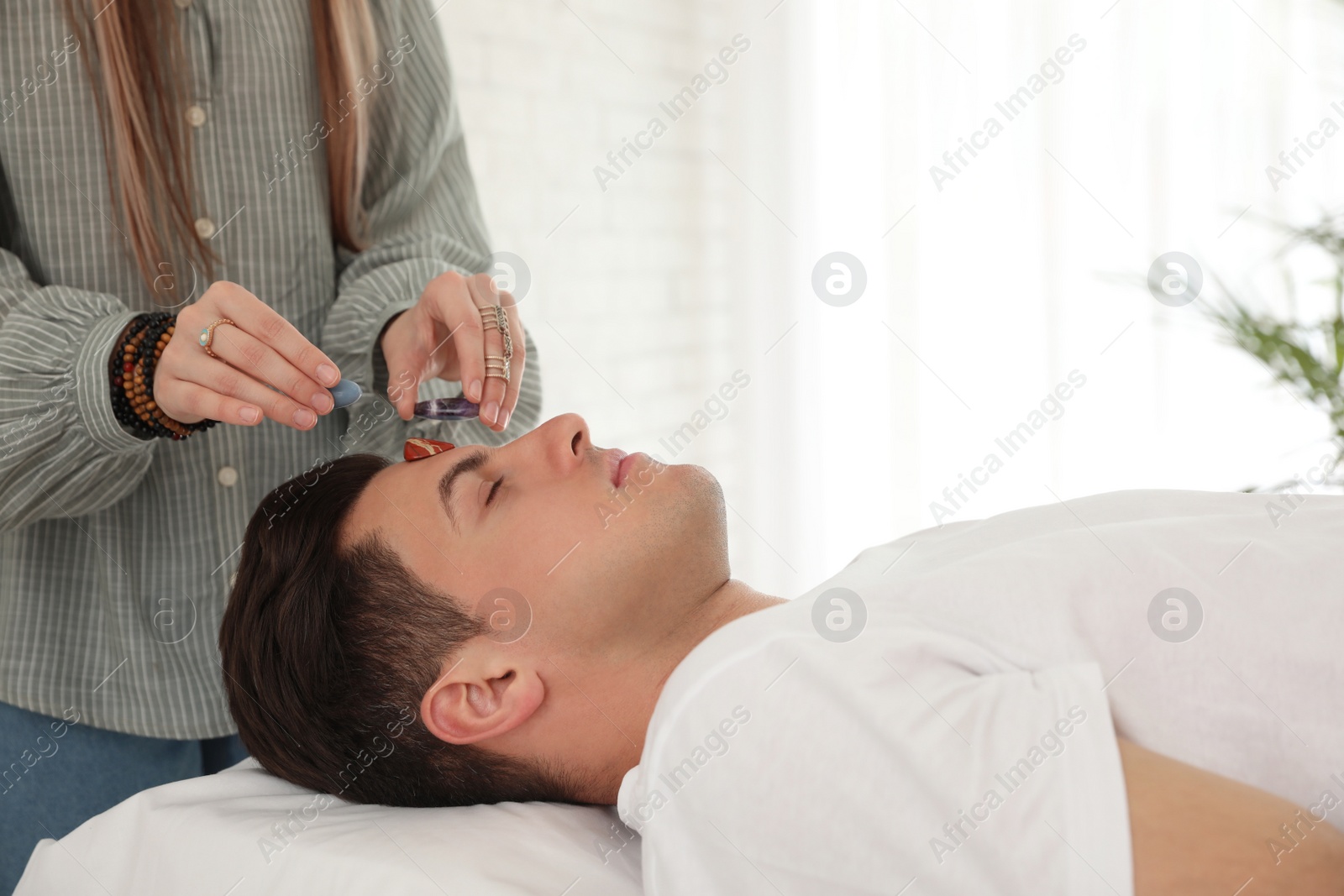 Photo of Man during crystal healing session in therapy room