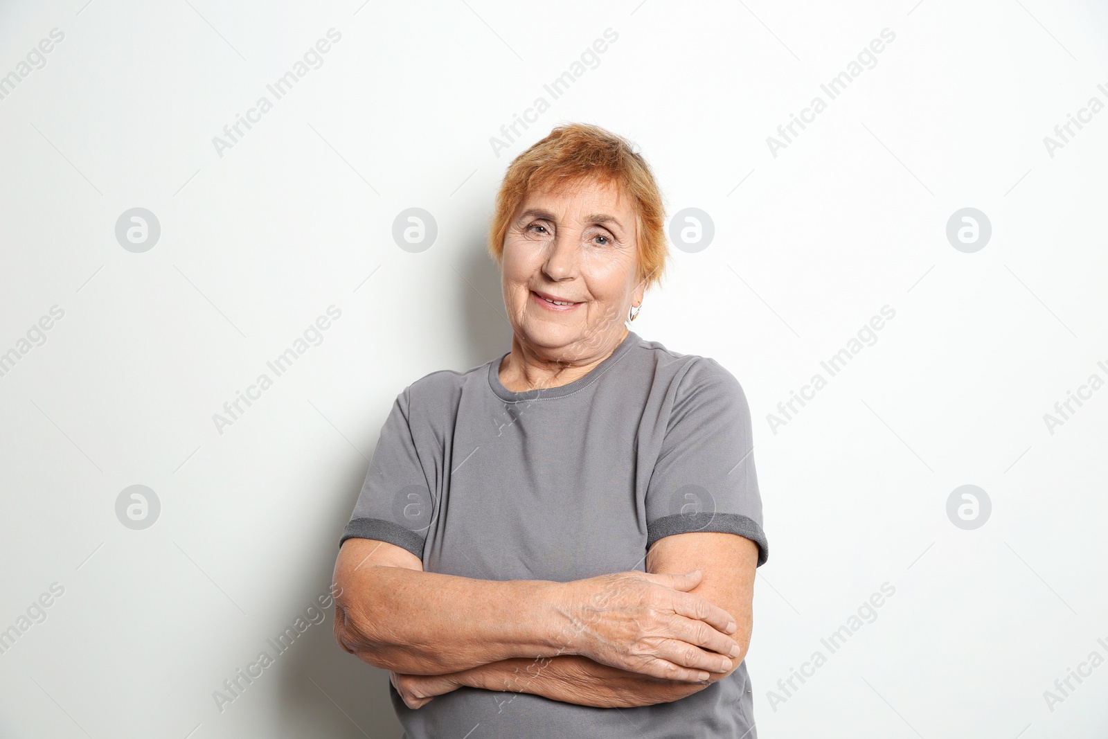 Photo of Portrait of elderly woman on light background